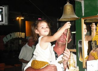 The Bunker Bar February ‘golfer of the month’ Peter Habgood gets some help ringing the bell from Lily.